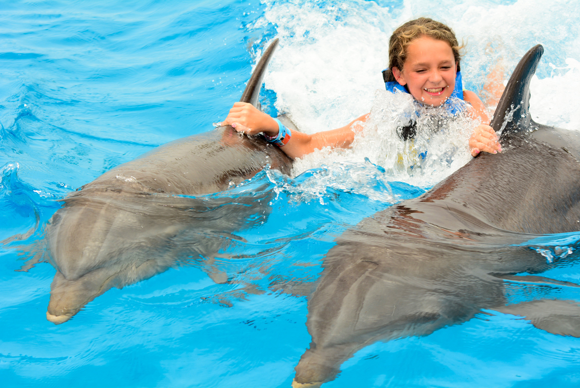 Virginia is all smiles on a ride with dolphins.