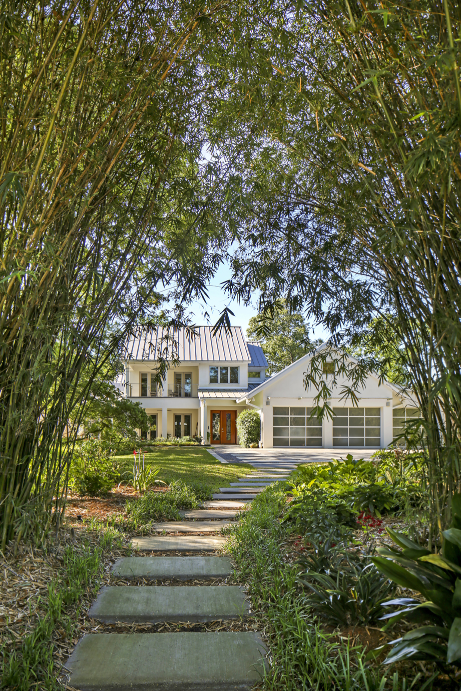 Mature bamboo offers ample privacy for this contemporary home in the heart of town. Landscape architect Bill Rountree handled the landscape design. Architect Lionel Bailey still included porches and overhangs—a nod to Southern style—but made it more simplistic in keeping with the sleek design the homeowners craved.