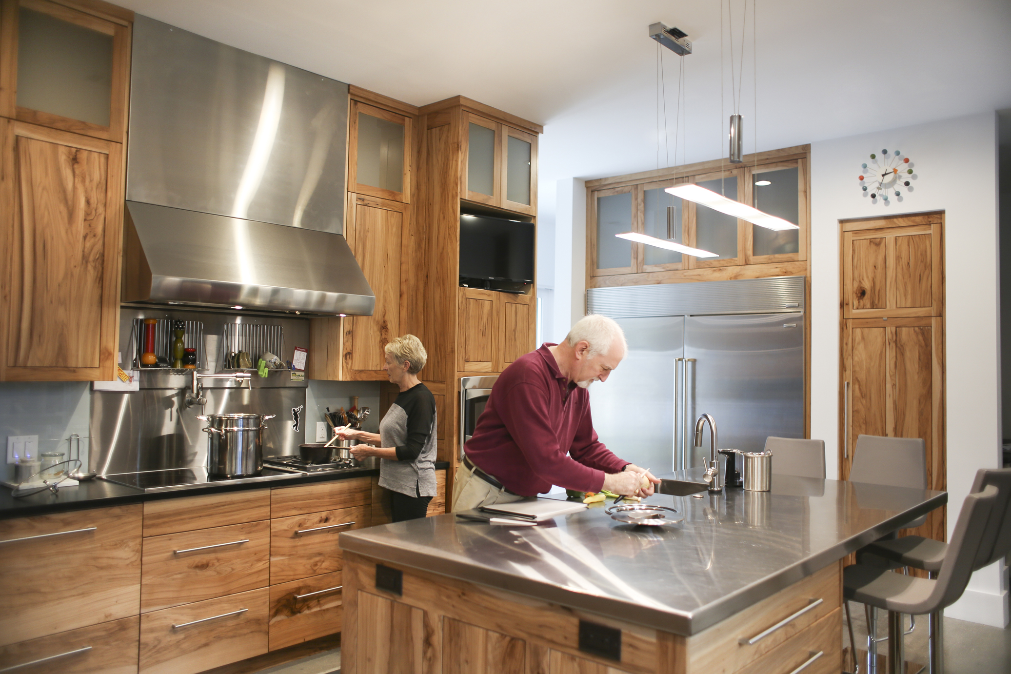 Tricia and Joe are avid cooks, so the kitchen had to be as functional as it is beautiful. “The greatest thing about this space is the storage and organization it allows,” says Tricia. “Joe really likes the induction cooktop and the warming drawer.” All countertops, besides the stainless steel on the island, are made from recycled paper.