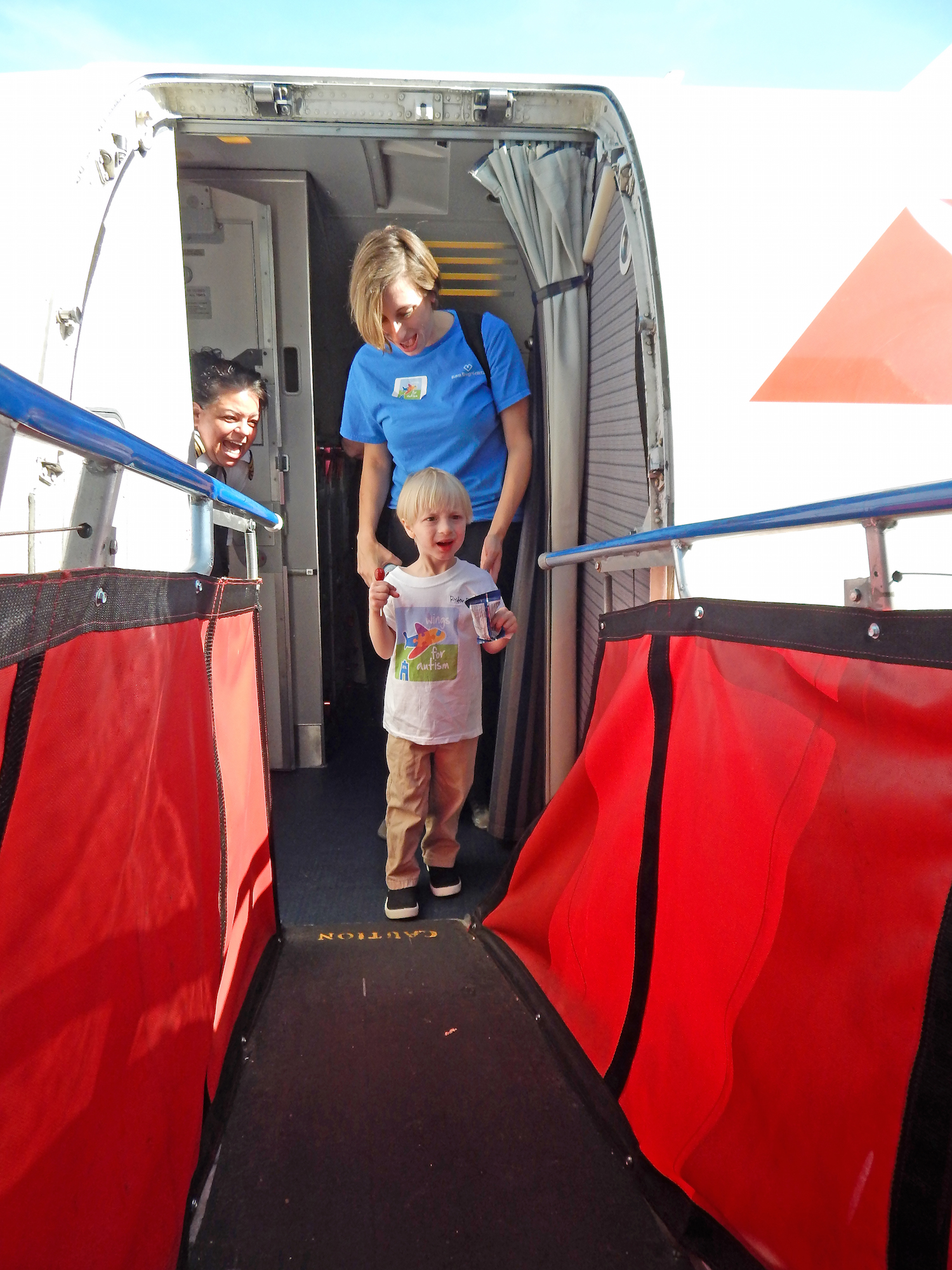 A young passenger-in-training exits the airplane during the Wings for Autism event in May.