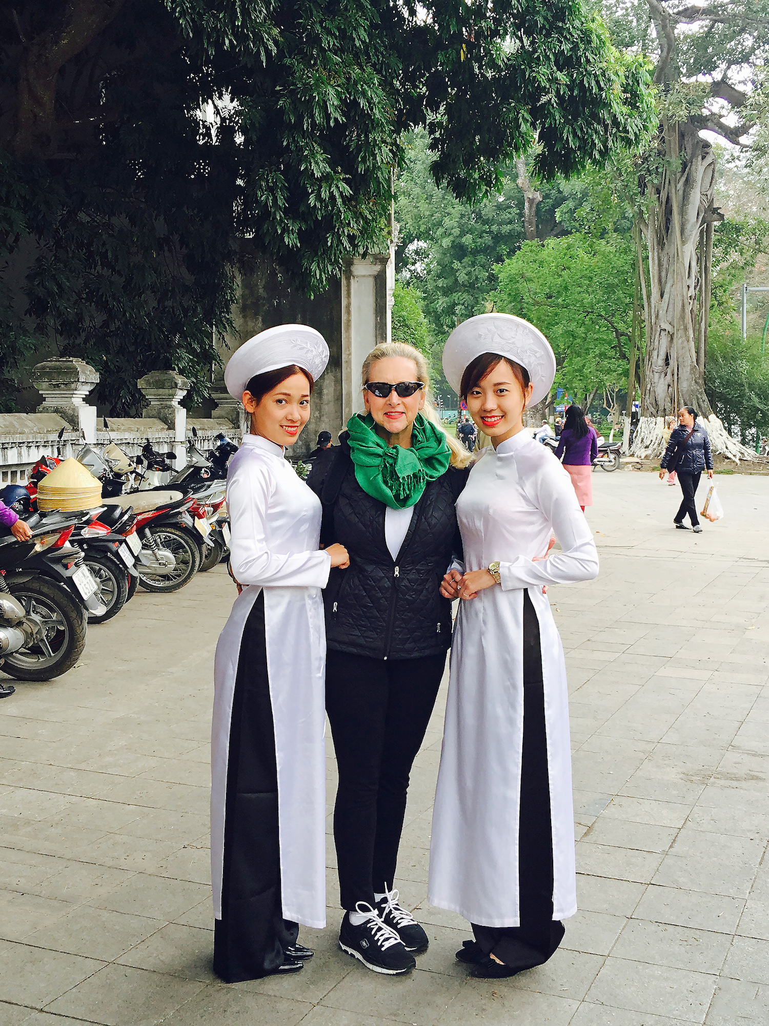 Astrid Clements with two Hanoi tour guides dressed in the traditional Vietnamese áo dài.