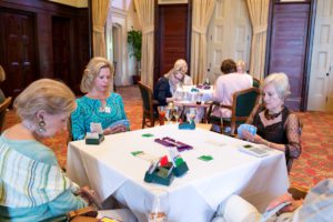 City Club bridge group co-founder Connie Hester (center) shares a game with Lynn Hatcher and Janie Hollowell.