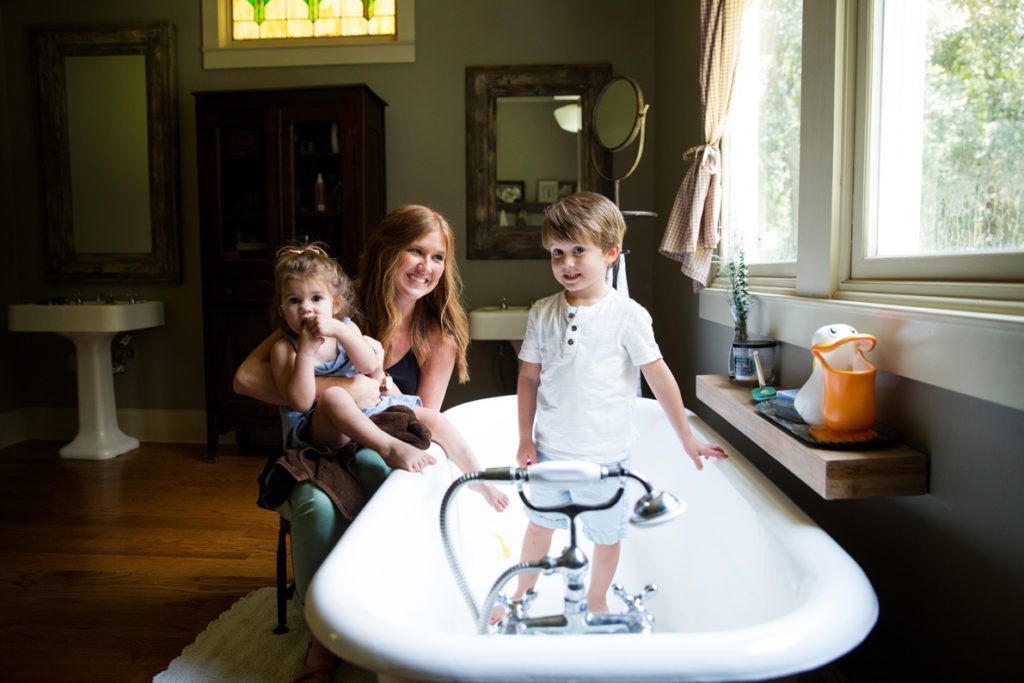Johnson and her husband Michael always loved old houses, but to suit their modern needs they built a replica of a historic home instead. Here, Johnson and her daughter Isla and son Finn hang out in the spacious bathroom, complete with clawfoot tub.