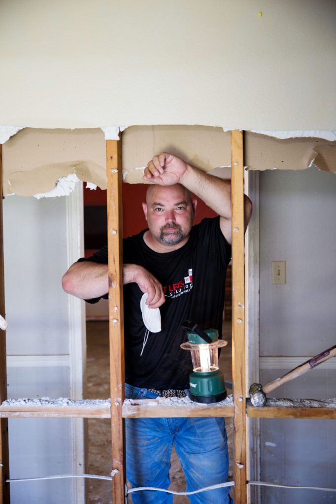 Shawn Goble stands inside his home in Denham Springs. His business partner Chris King at Baton Rouge business support services firm Next Level Solutions took the first steps to mobilize the manpower behind the Cajun Navy into boots-on-the-ground work to clean up after the storm through an initiative now known as the Cajun Army. “I lost everything that didn’t matter,” Goble says. “What’s left, the Amite can have it.” Photo by Collin Richie.