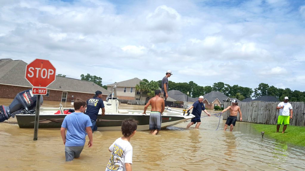 Suburban streets became rivers as volunteers launched boats all over south Louisiana, including this scene in the Southpoint neighborhood of Denham Springs. Photo courtesy Jeremy Higginbotham.