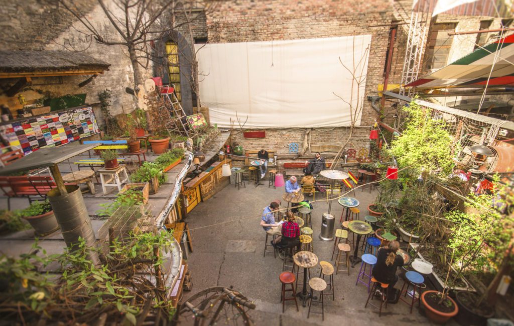 Budapest, Hungary - Mars 31, 2016: Outdoor terrace of one of the most attractive and touristic ruin pubs, the Szimpla, at Kazinczy street. Ruin pubs, most in District VII, former Jewish quarter, are a trend of Budapest cultural and night life.