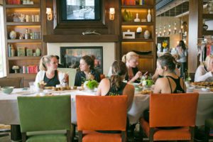 Tread to Table attendees gather for breakfast inside L'Auberge's rooftop VIP room.