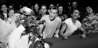 A black and white photo by famous photographer Bob Willoughby that shows Big Jay McNeely driving the crowd into a frenzy during a show at Olympic Stadium in Los Angles CA circa 1951
