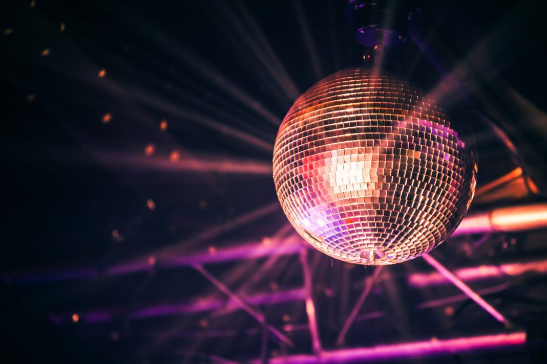 Disco ball with bright rays, night party