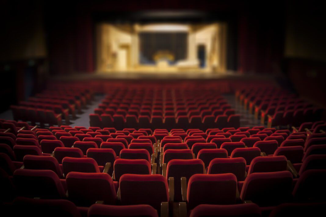 Empty red armchairs of a theater ready for a show