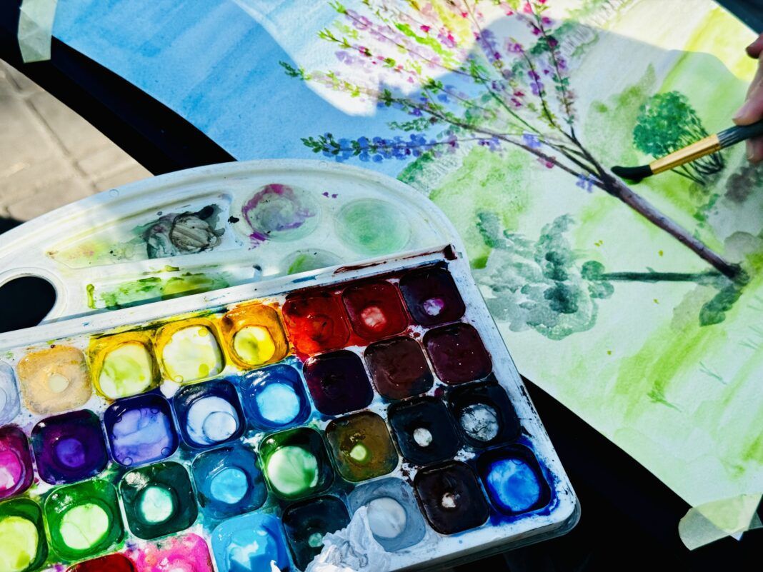 Artist painting a Tree with Watercolors